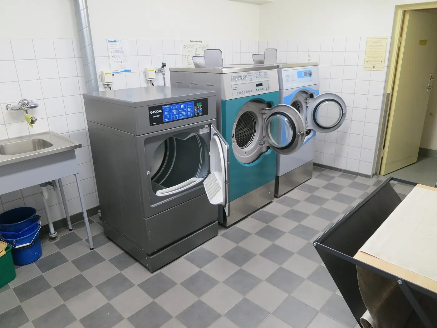 Communal laundry room fitted with modern washing machines