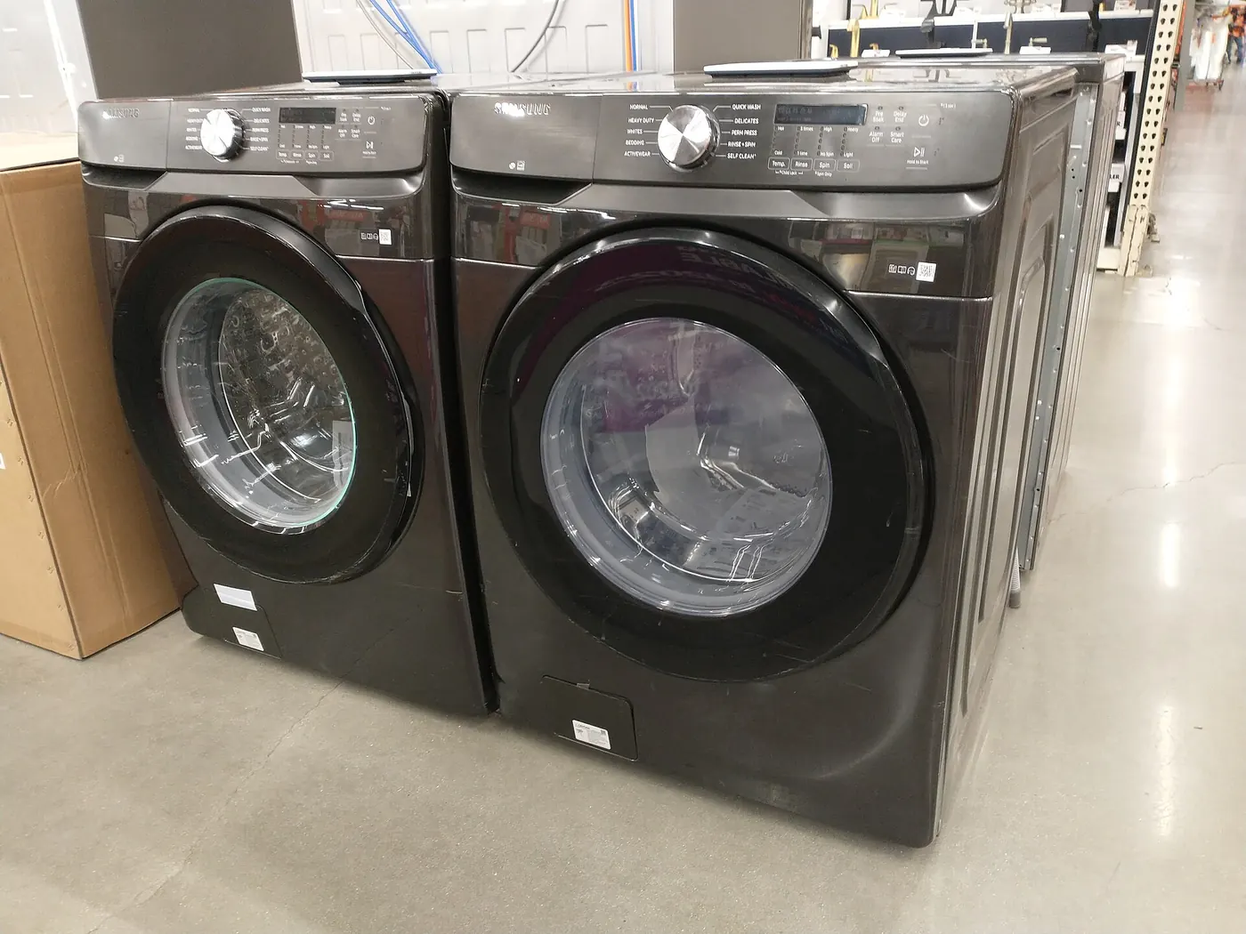Rows of washing machines displayed in an appliance showroom