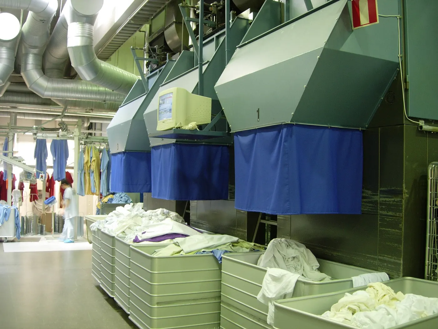 Industrial laundry linen press line installed in a plant
